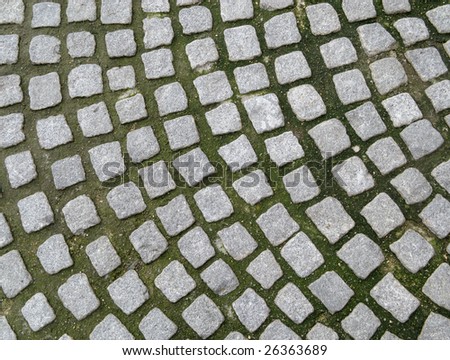 Close up of old cobblestones paving.