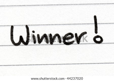 Writing winner with black ink on white paper.