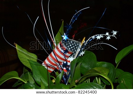 U.S. flag decorated with stars and spangles in red, white and blue arranged in ivy planter