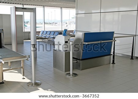 The waiting area - behind the security entrance and desk - of an airport terminal
