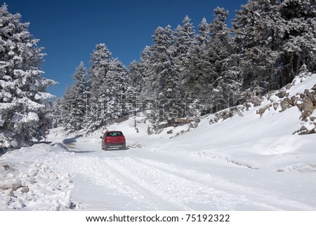 A car in a snow-covered road of mount Parnassos, central Greece