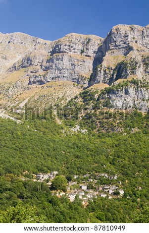 The village of Little Papigo below the huge steep cliffs (called \
