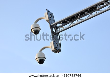 Close up of Dome type CCTV camera against the blue sky.