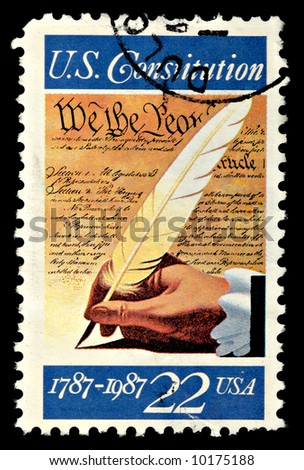 A U.S. .22 cent stamp with the United States Constitution on the face isolated on a black background.