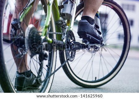 cyclist presses on the pedal.