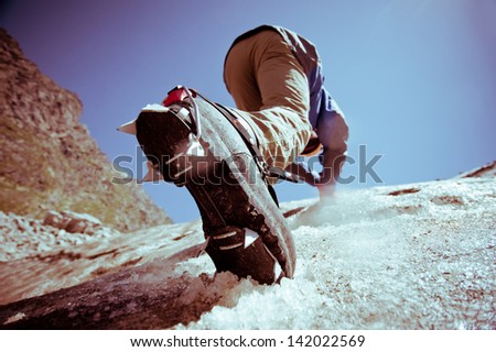 Climber climbs on ice.