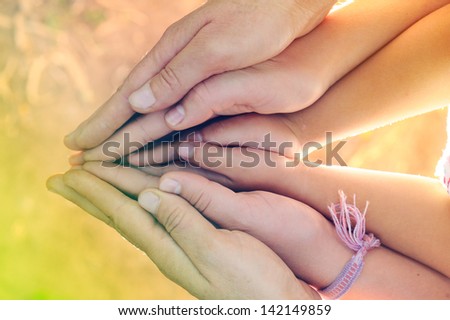 hands of  family in  conceptual position.