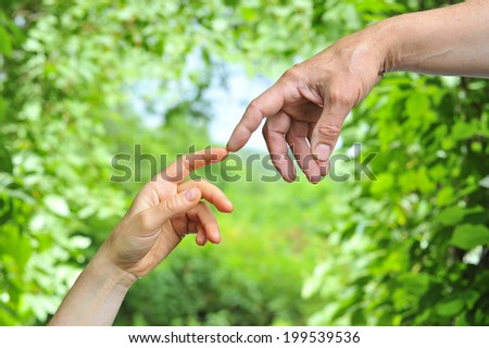 man\'s hand reaches for the female palm