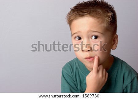 Boy Pointing to side of Mouth