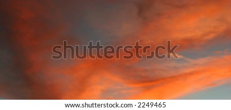 Bright Orange and Pink, Cloudy Sunset for use as a Background
