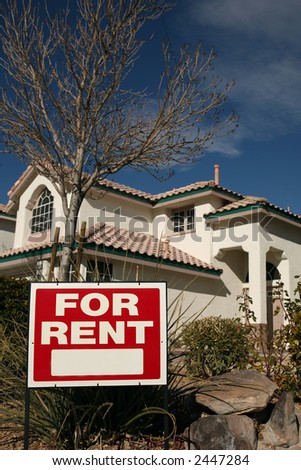 For Rent Sign with a House in the Background and Copy Space