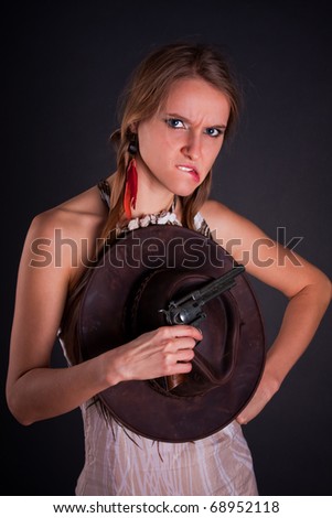 The American Indian girl with a cowboy\'s hat holds a pistol