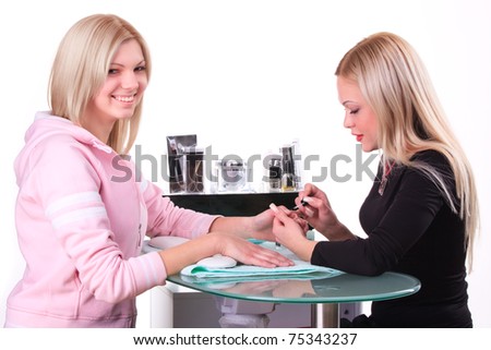 Manicure process. Pro at work with her client.