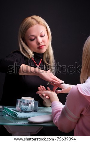 Manicure process. Pro at work with her client.