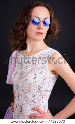 Portrait of beautiful woman in a lilac dress in blue sunglasses