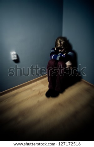 sad woman sitting alone in a empty room