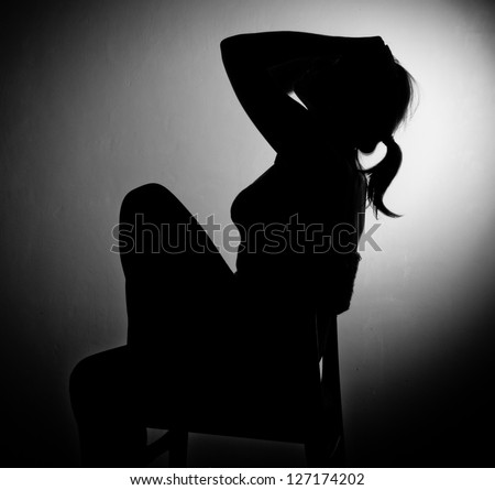 sad woman sitting alone- black and white