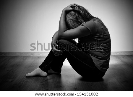 Sad Woman Sitting Alone In A Empty Room