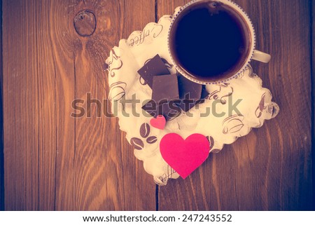Coffee and chocolate, in the background of the heart from the carton. Valentine\'s Day. Retouching in retro style