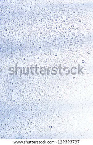 Water drop and droplet on mirror bright white and blue background