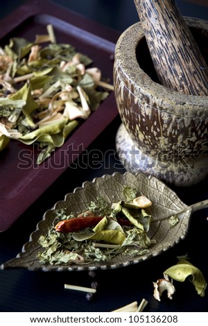 dried herbs and spices with mortar