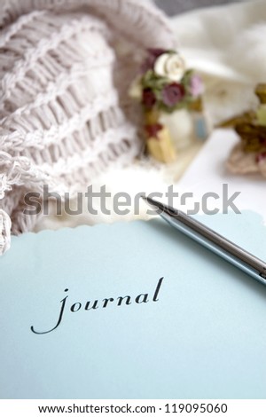 journal book with pen put on soft scarf