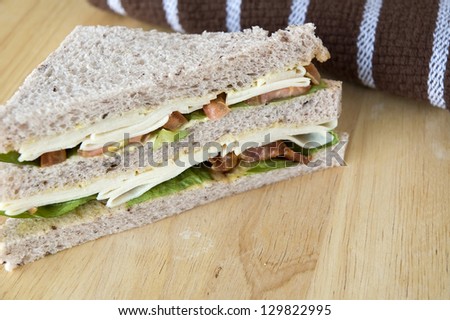 chicken and bacon sandwich on wooden table