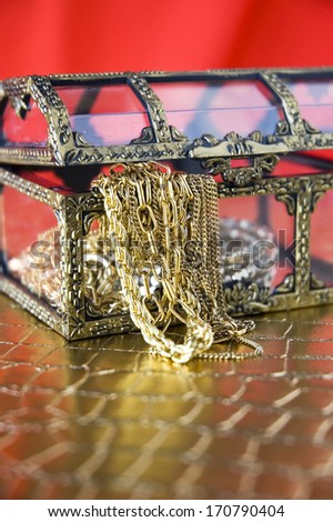 golden jewelry in open treasure chest