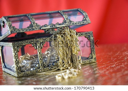 jewelry in treasure chest with red background