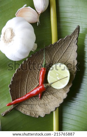 spicy ingredients on golden leaf tray put on banana leaf