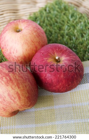fresh three apples on picnic mat