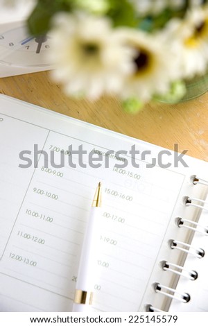 planner book with pen on table
