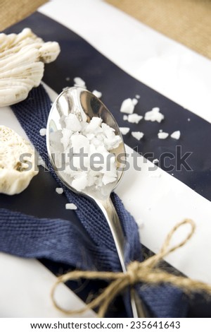 sea salt in spoon put on navy blue and white background