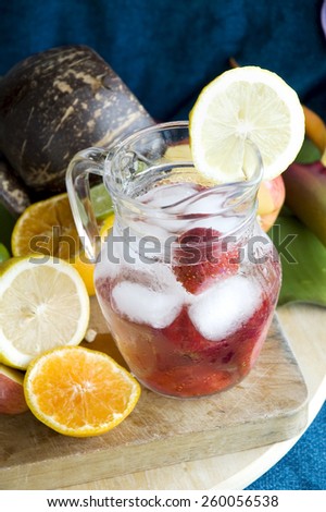 cool drink with strawberry and lemon in glass jar
