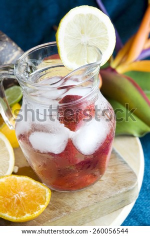 fresh cool drink with strawberry and fruits on background