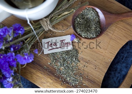 close up tea time tag with dried tea on wooden board