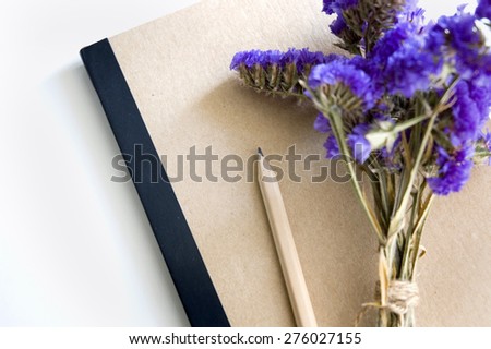 natural color book and pencil with purple flowers