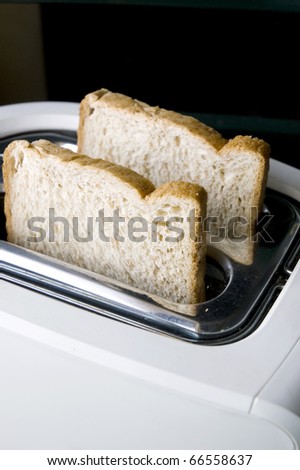 Wheat breads prepare on white toaster.