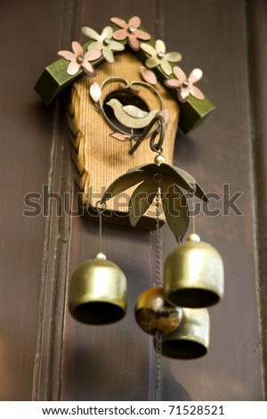sweet bell wind chimes on wood wall.