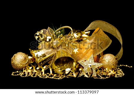 Gold Christmas decorations. Boxes, ribbons, stars, bells on black background