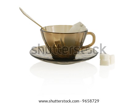 empty glass transparent cup with cookie, sugar anf package tea