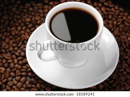 Cup of coffee. A background with coffee grains and a white cup
