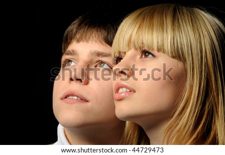 Young enamoured pair. A romantic atmosphere. A dark back