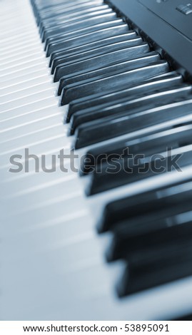 Keys of the piano. A photo close up. Blue tone.