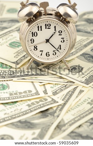 Time - money. Business concept. Analog hours on a heap of paper dollars