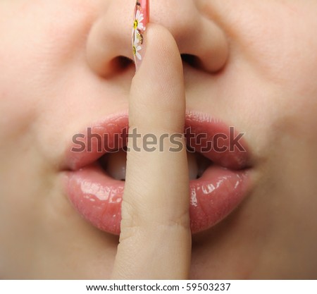Finger at a mouth. Gesture designating silence