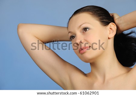 The beautiful young woman. Natural beauty. It is isolated on a blue background