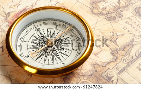 Old compass on ancient map. A compass with the antique image of a direction
