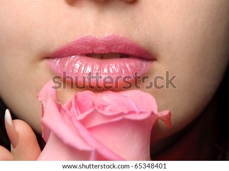 The woman with a rose. A photo close up parts of the person and a flower
