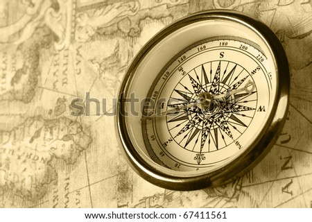 Old compass on ancient map. Old monochrome image